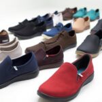 A variety of Xero Shoes slip-ons in different colors and styles—with the most cushion—are arranged in rows on a white surface. Your ultimate guide to vibrant footwear includes shades of red, blue, black, brown, beige, and teal.